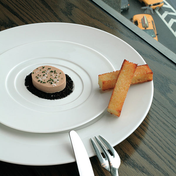 Hommage presentation round center plate by Raynaud, wide-rimmed fine porcelain handcrafted in France for elegant dining presentations.