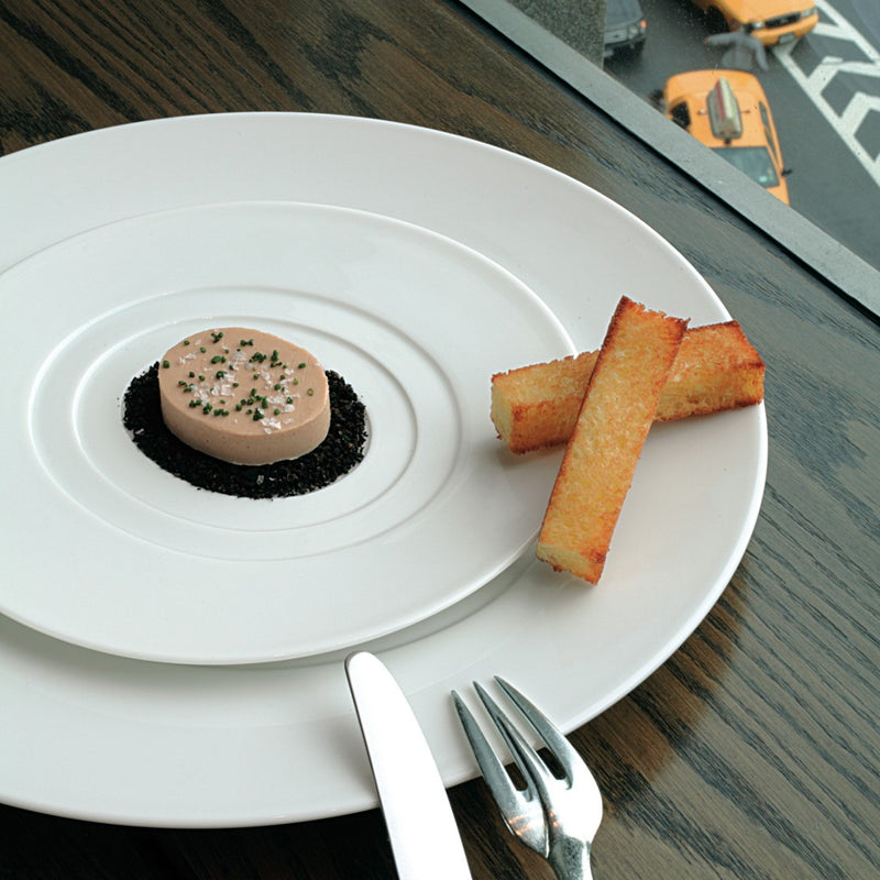 Hommage presentation round center plate by Raynaud, wide-rimmed fine porcelain handcrafted in France for elegant dining presentations.