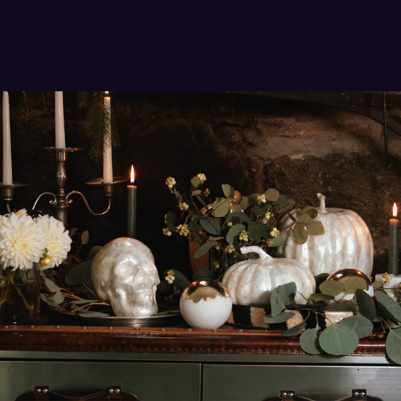 halloween setup decor counter with capiz white pumpkins, skulls and flowers