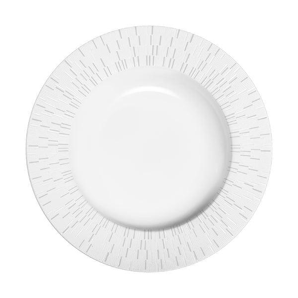 A white porcelain soup plate with a sunburst pattern design on the rim.