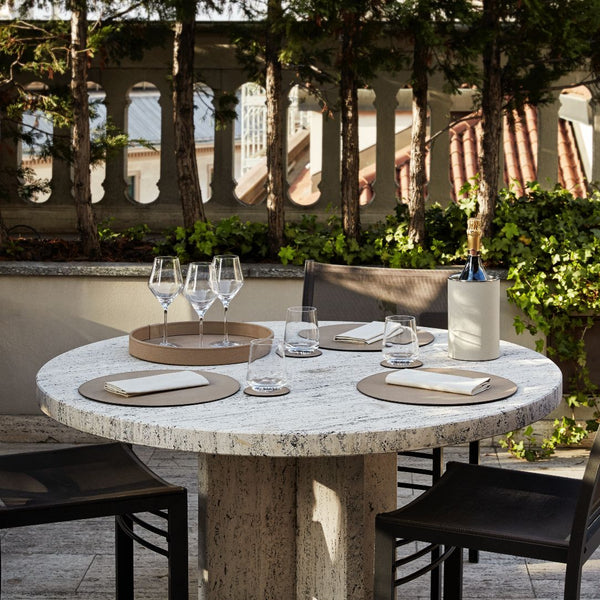 styled outdoor table with the Round leather coaster in taupe by Pinetti