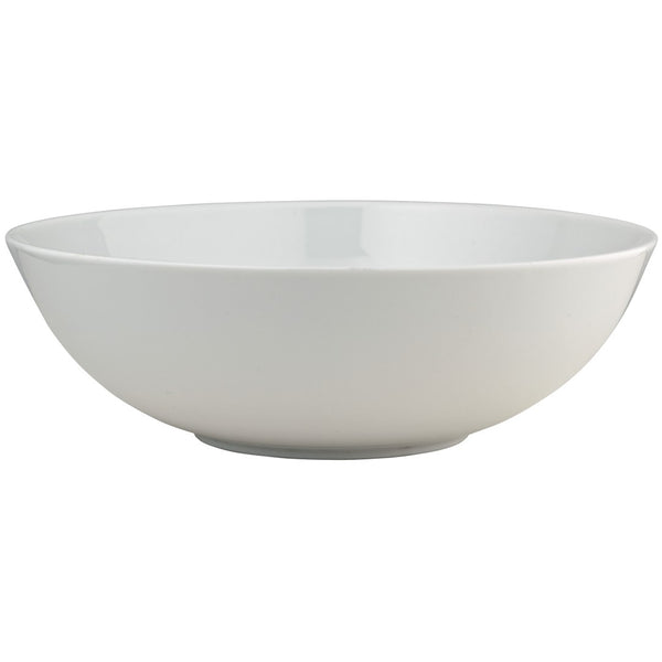 A white porcelain salad bowl with a smooth, rounded design from the 'Uni' Collection by Raynaud.