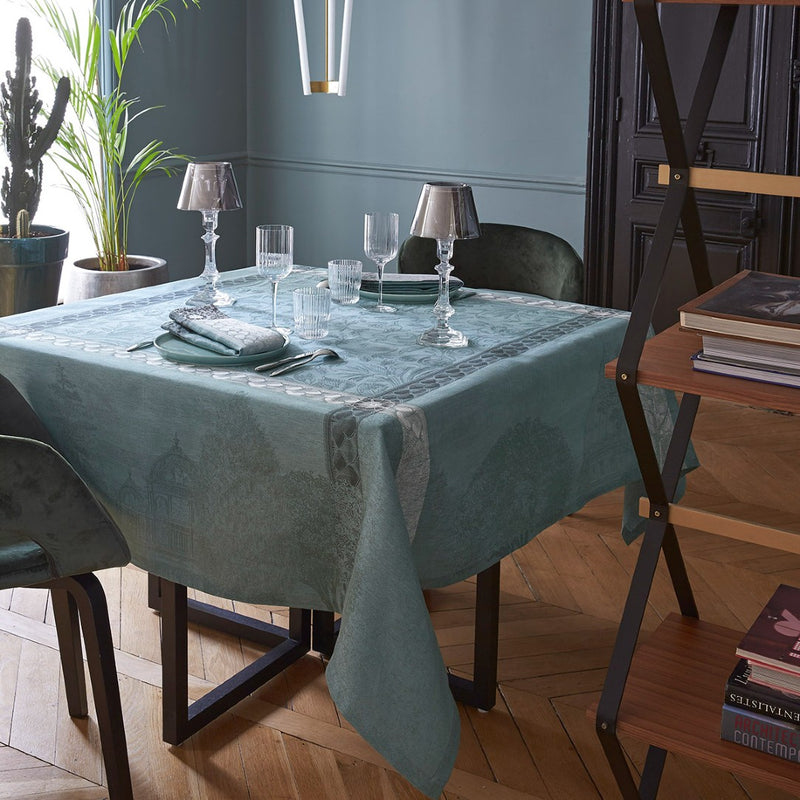 Dining room featuring a styled dining table with a green tablecloth and table lamps