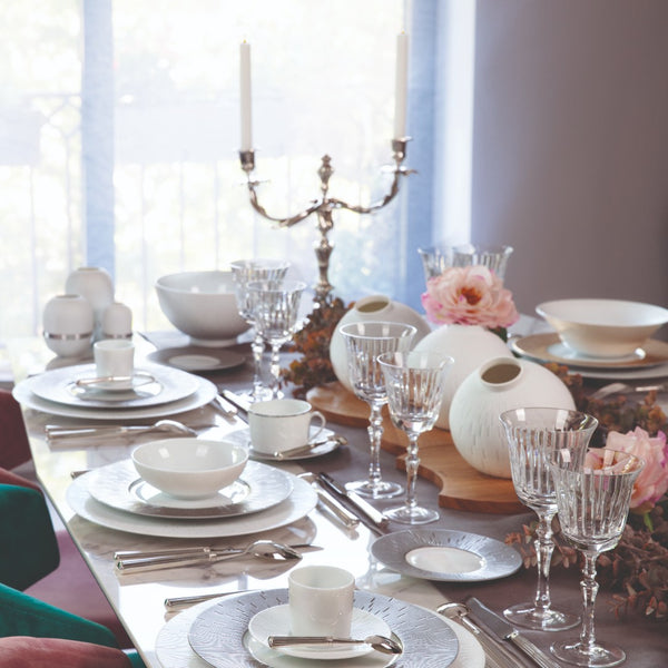 table decoration featuring white porcelain bowls and plates from Haviland Infini collection styled with flowers and glassware