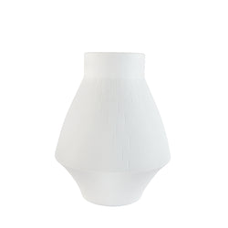 A white porcelain vase with a modern and timeless engraving, conical in shape with a flared top.