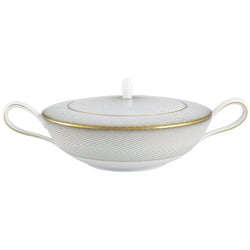 A white, gold, and brown Raynaud porcelain soup tureen with geometric patterns.
