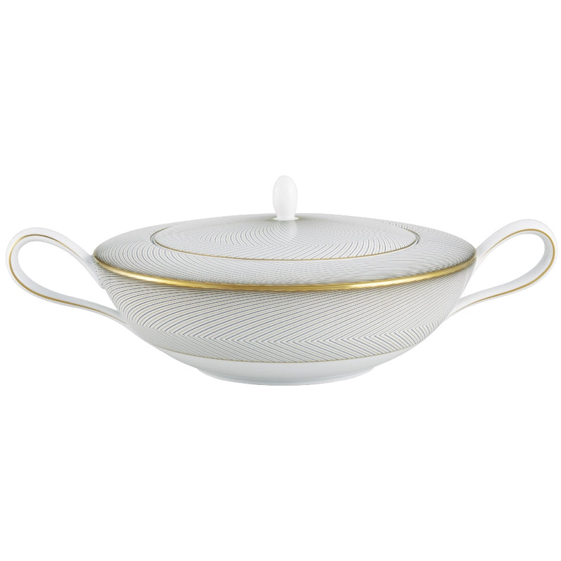 A white, gold, and brown Raynaud porcelain soup tureen with geometric patterns.