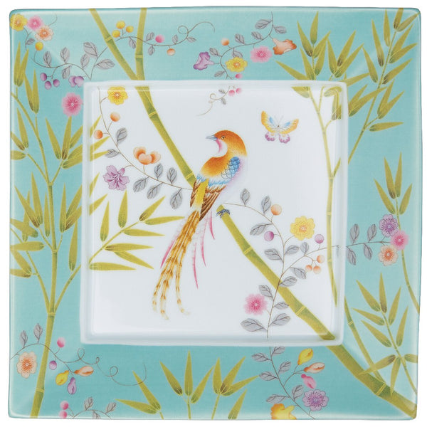 A square porcelain trinket tray with turquoise background and a bird motif in the center, surrounded by floral patterns.