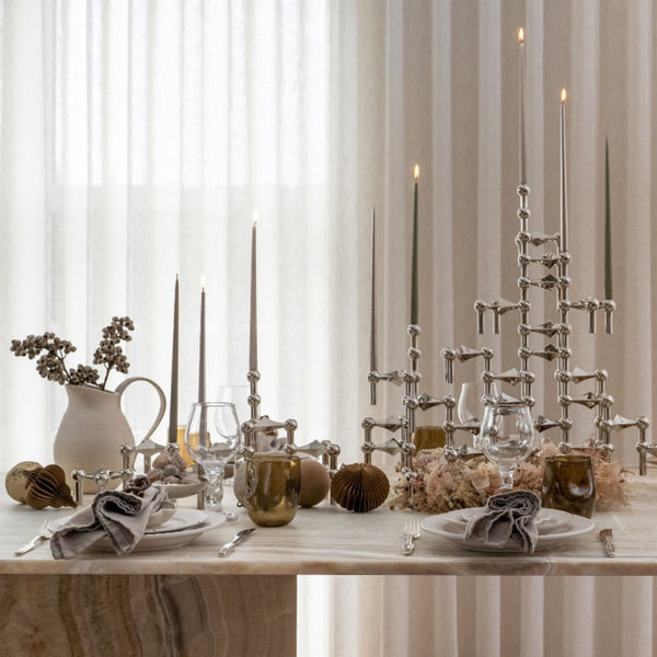 modern festive table decorated with Stoff Nagel candle holder  in chrome, modular sculptural holders 