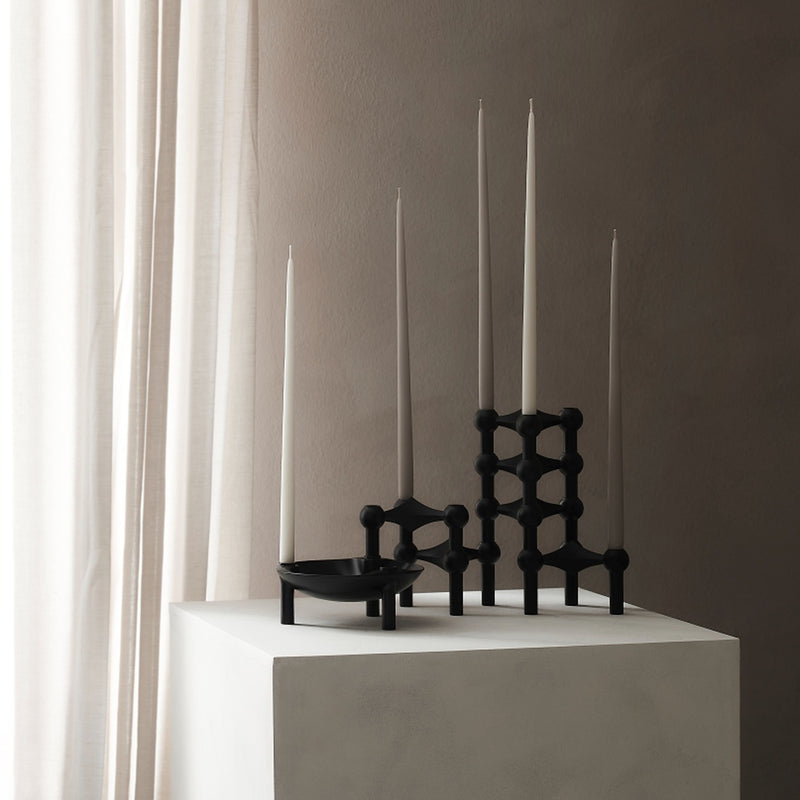 styled window with the black sculptural stacked candle holder in black by stoff nagel