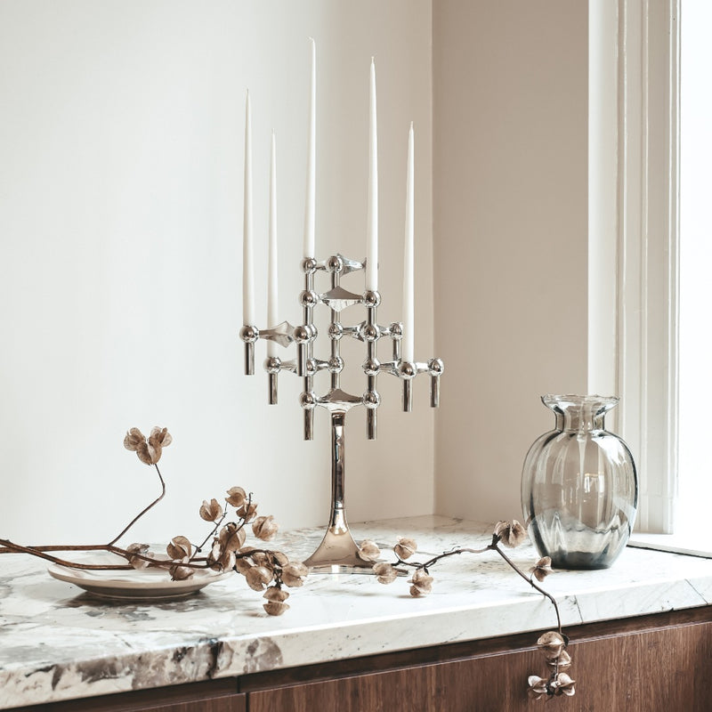 stoff nagel candle holder with slim taper candles in white styled on a counter