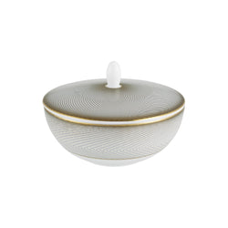 A white porcelain sugar bowl with geometric gold and black motifs, and a gold rim.