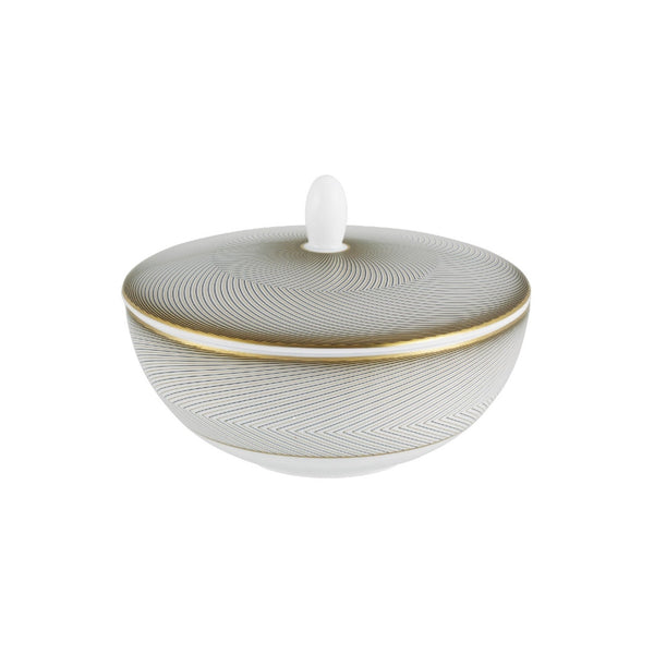 A white porcelain sugar bowl with geometric gold and black motifs, and a gold rim.