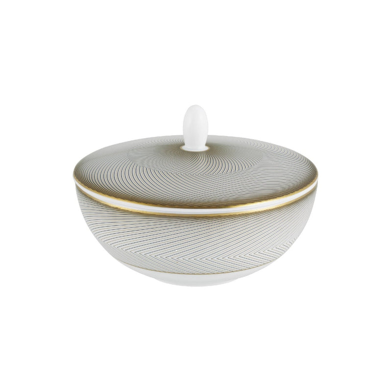 A white porcelain sugar bowl with geometric gold and black motifs, and a gold rim.