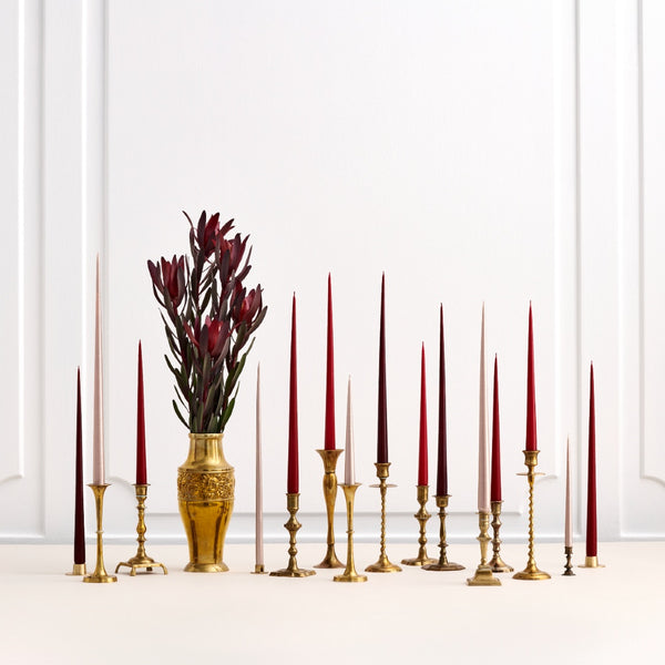styled red, brown and gold taper candles and flower vase in gold