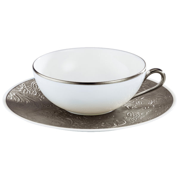 A white porcelain tea cup with a platinum floral pattern and a matching saucer, set on a white background.