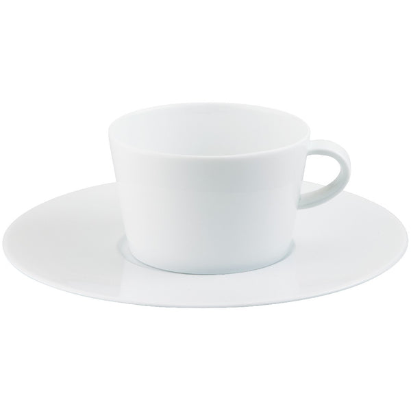 Hommage tea cup and saucer by Raynaud, fine porcelain handcrafted in France with wide-rim layered design for luxury yachts, villas, and refined dining.


