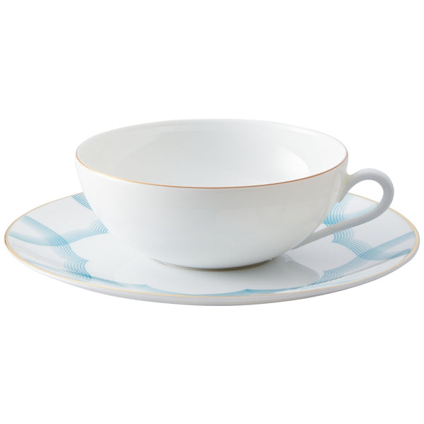 Tea Cup and Saucer Aura by Raynaud in fine Limoges porcelain with golden rim and blue scalloped accents.
