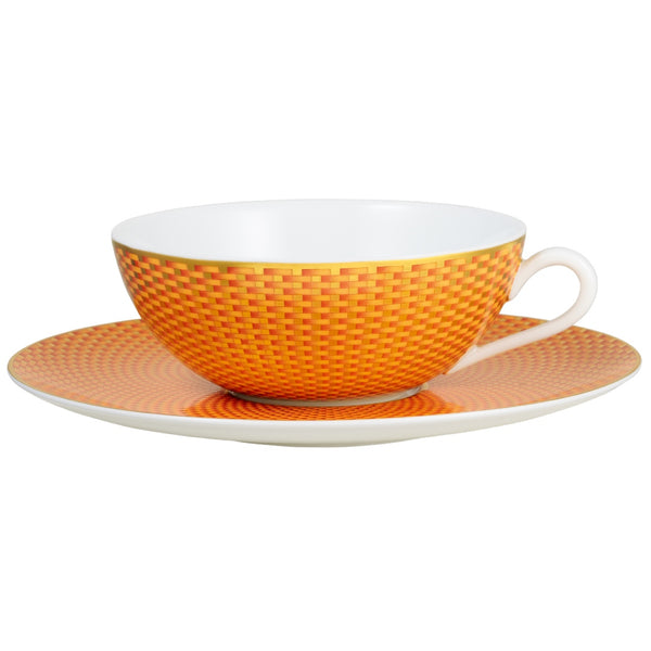 Raynaud Trésor orange porcelain tea cup and saucer with gold-accented honeycomb design