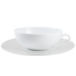 A white porcelain tea cup with a saucer from the "Uni" Collection by Raynaud.