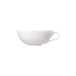 A white porcelain tea bowl with a smooth finish and a subtle indentation pattern on the side.