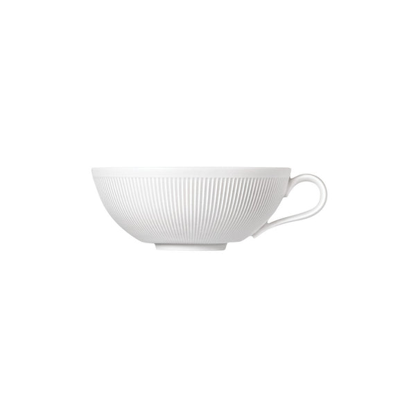 A white porcelain tea bowl with a smooth finish and a subtle indentation pattern on the side.