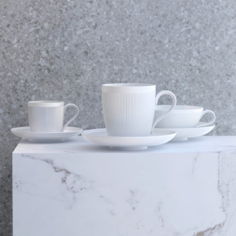 3 cups with saucers Stella Satin White velvety matte by SIEGER by FÜRSTENBERG on a marble surface