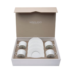 A set of 4 white porcelain tea cups and saucers presented in an open gift box with the Haviland brand visible.
