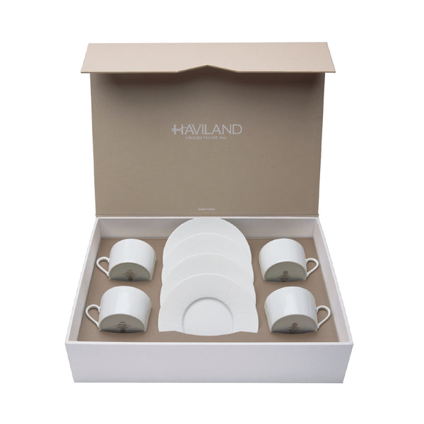 A set of 4 white porcelain tea cups and saucers presented in an open gift box with the Haviland brand visible.