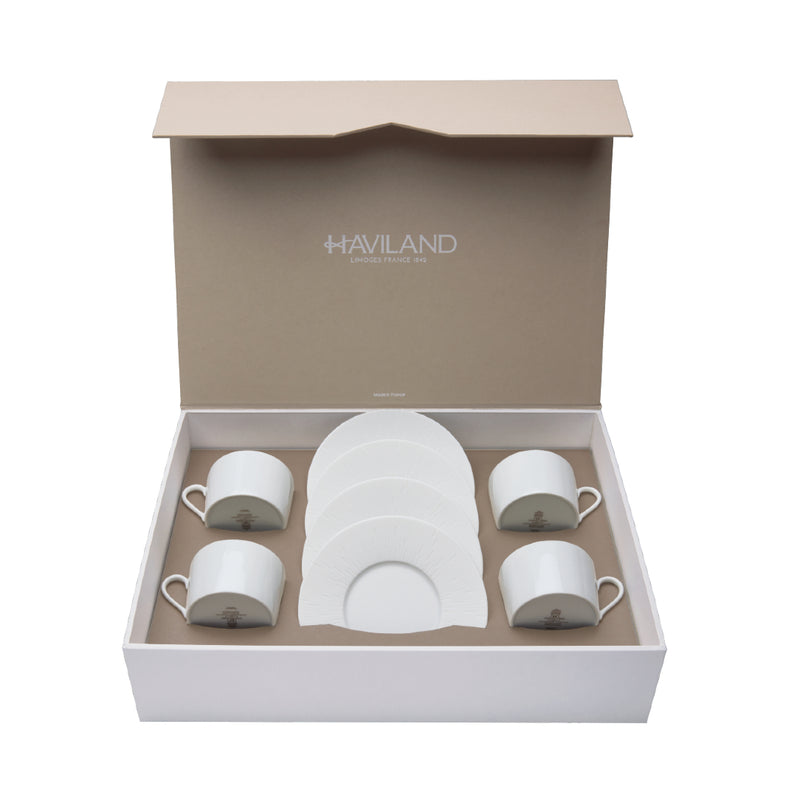 A set of 4 white porcelain tea cups and saucers presented in an open gift box with the Haviland brand visible.