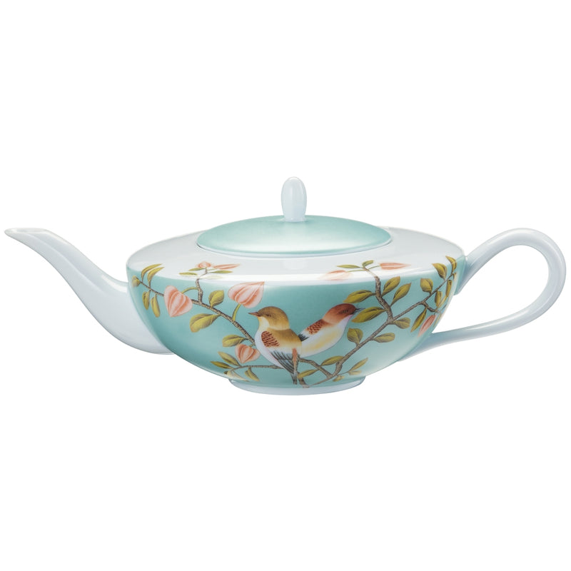A turquoise and white Limoges porcelain tea pot with birds and floral patterns, featuring a lid and handle.