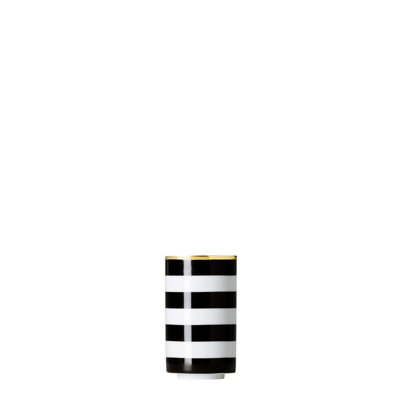 A cylindrical porcelain tea strainer beaker with black and gold stripes on a white background.