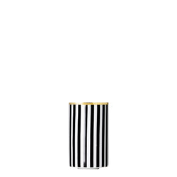 A cylindrical porcelain tea strainer beaker with black and gold stripes and geometric patterns.
