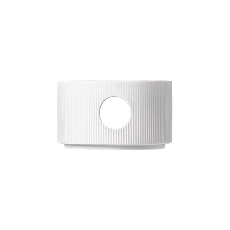 A white porcelain teapot warmer with a star-like pattern and a circular opening for tea pouring, from the STELLA series by Sieger by Fürstenberg.