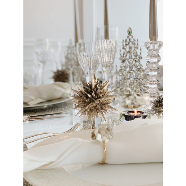 table decor styled showing dark silver glitter 3D star ornament, napkins and topiary trees with crystals