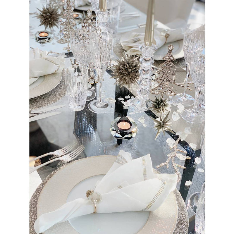 table decor showing silver ornaments decorated table with white and silver plates and placemats