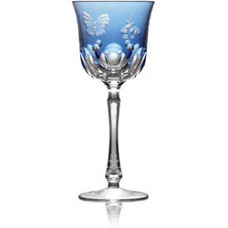 A sky blue colored water glass with hand-engraved floral and insect motifs on the side.