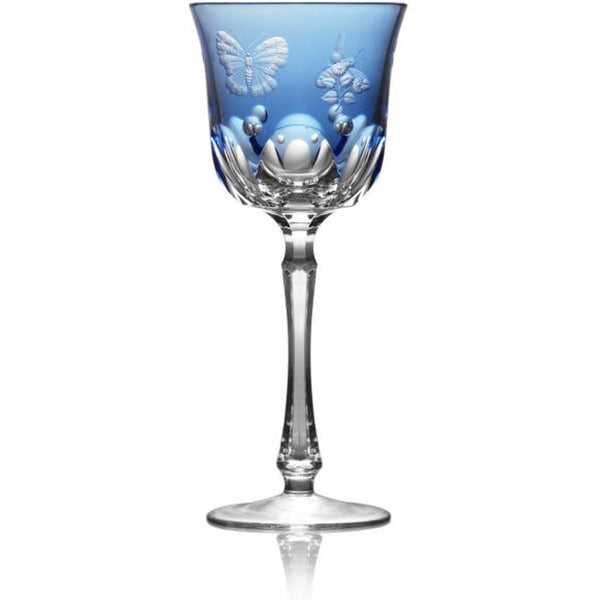 A sky blue colored water glass with hand-engraved floral and insect motifs on the side.