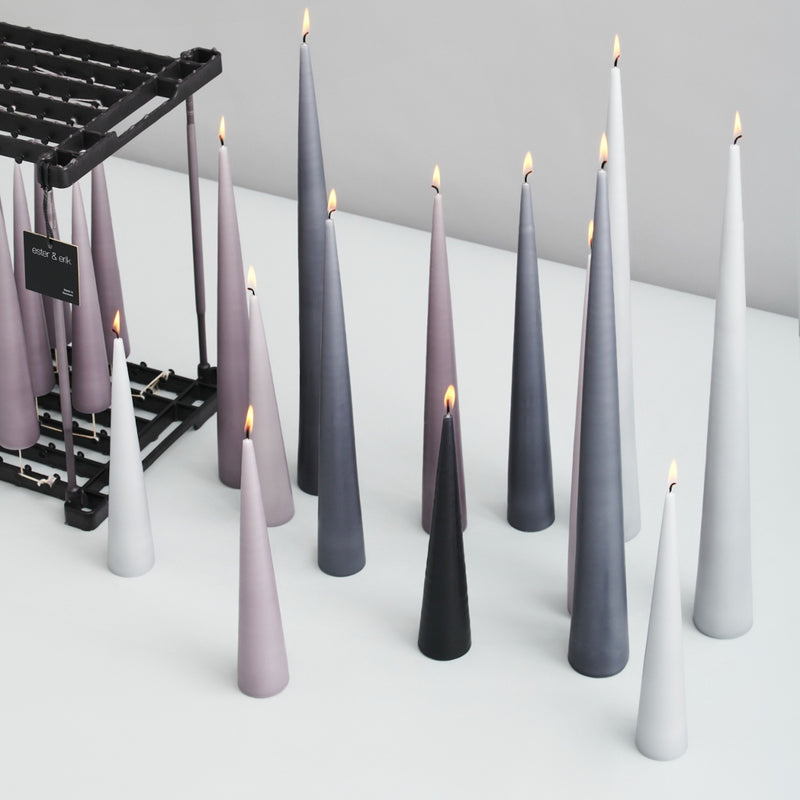 styled and lit white and green cone candles