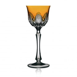 An amber-colored wine glass with a traditional cutting technique, part of the Captiva Collection.