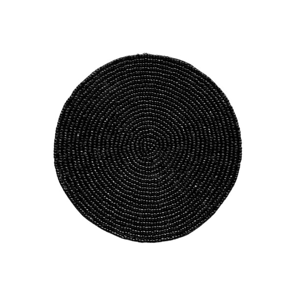 A round, black beaded drink coaster with cotton backing.